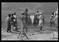 [Untitled photo, possibly related to: Buying produce at the waterfront in Christiansted. Most of the food comes in little schooners from Puerto Rico and the neighboring islands. Virgin Islands]. Sourced from the Library of Congress.
