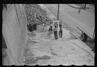 San Juan, Puerto Rico. People carrying water home because of the failure of the water system for three days. Sourced from the Library of Congress.