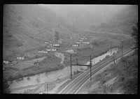 [Untitled photo, possibly related to: Houses in abandoned mining town with remains of coal tipple at right, Mohegan, West Virginia]. Sourced from the Library of Congress.