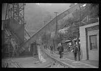 Miners starting home after work. Part of coal tipple shown at left. West Virginia. Sourced from the Library of Congress.