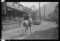 Miner taking home provisions, Caples, West Virginia. Sourced from the Library of Congress.