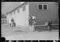 [Untitled photo, possibly related to: Miner taking home provisions, Caples, West Virginia]. Sourced from the Library of Congress.
