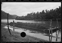 [Untitled photo, possibly related to: Coal barge on river, Scotts Run, West Virginia]. Sourced from the Library of Congress.