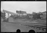 [Untitled photo, possibly related to: Part of coal mine tipple with workers' homes in background. Pursglove Cleaning Plant No. 2, West Virginia]. Sourced from the Library of Congress.