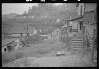 [Untitled photo, possibly related to: Coal miner's wife getting water from pump, company houses, Pursglove, Scotts Run, West Virginia]. Sourced from the Library of Congress.