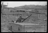 Coal miners switching motor. Note live wires. The "Patch," Chaplin, West Virginia. Sourced from the Library of Congress.