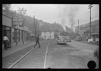 [Untitled photo, possibly related to: Train pulling coal through center of town morning and evening, Osage, West Virginia]. Sourced from the Library of Congress.
