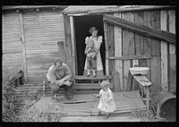 [Untitled photo, possibly related to: Coal miner and some of his family in back of their home. Bertha Hill, West Virginia]. Sourced from the Library of Congress.