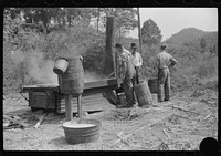 [Untitled photo, possibly related to: Boiling juice of sugarcane into sorghum molasses. Racine, West Virginia]. Sourced from the Library of Congress.