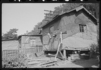 Shacks inhabited by es along river on highway between Charleston and Gauley Bridge, West Virginia. Sourced from the Library of Congress.