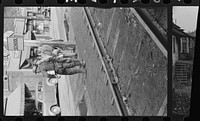 [Untitled photo, possibly related to: Coal miners waiting for bus to go home, Osage, West Virginia]. Sourced from the Library of Congress.