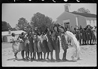 Florence Wright, recreation supervisor, starts off a game during outdoor class with schoolchildren, Gees Bend, Alabama. Sourced from the Library of Congress.