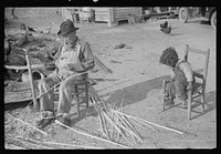 [Untitled photo, possibly related to: Mixed-breed Indian, white and , near Pembroke Farms, making new chair seat. North Carolina]. Sourced from the Library of Congress.