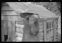 [Untitled photo, possibly related to: Pauline Clyburn, rehabilitation borrower, Manning, Clarendon County, South Carolina, and her son repairing home]. Sourced from the Library of Congress.