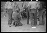 [Untitled photo, possibly related to: Vegetable pickers, migrants, waiting after work to be paid. Near Homestead, Florida]. Sourced from the Library of Congress.