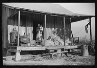 Home of  wagehand, Knowlton Plantation, Perthshire. On the porch are sacks of cotton. Mississippi, Delta Mississippi. Sourced from the Library of Congress.