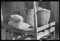 [Untitled photo, possibly related to: Sacks of cotton on wagehand's porch. Knowlton Plantation, Perthshire, Mississippi Delta, Mississippi]. Sourced from the Library of Congress.