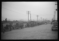 [Untitled photo, possibly related to: Day laborers being hired for cotton picking on Mississippi and Arkansas plantations. Between four and six-thirty every morning during the season, near the Hallan Bridge in Memphis, Tennessee, crowds of es in the streets gather and are loaded into trucks by drivers who bid, and offer them anywhere from fifty cents to one dollar per day]. Sourced from the Library of Congress.