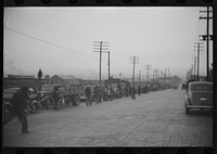 [Untitled photo, possibly related to: Day laborers being hired for cotton picking on Mississippi and Arkansas plantations. Between four and six-thirty every morning during the season, near the Hallan Bridge in Memphis, Tennessee, crowds of es in the streets gather and are loaded into trucks by drivers who bid, and offer them anywhere from fifty cents to one dollar per day]. Sourced from the Library of Congress.