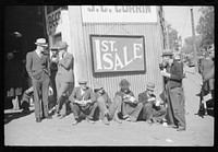 Farmers eat a lot of ice cream and drink lots of beer while waiting for tobacco to be sold at auction sales outside warehouse, Durham, North Carolina. Sourced from the Library of Congress.
