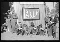 [Untitled photo, possibly related to: Farmers eat a lot of ice cream and drink lots of beer while waiting for tobacco to be sold at auction sales outside warehouse, Durham, North Carolina]. Sourced from the Library of Congress.