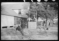 Men drinking from well on farm near the Fred Wilkins place. They have been shucking corn. Granville County, North Carolina. Sourced from the Library of Congress.