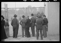 [Untitled photo, possibly related to: Spectators standing outside the gate of the Duke University Stadium because there were no more seating accomodations. Duke University-North Carolina game. Durham, North Carolina]. Sourced from the Library of Congress.