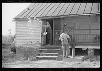 Men who were helping with corn shucking going into house to wash up before dinner. Fred Wilkins farm. Tally Ho, near Stem, Granville County, North Carolina. Sourced from the Library of Congress.