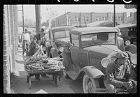 [Untitled photo, possibly related to: Farmers bring their tobacco in trailers and sometimes in their cars to the warehouse where it will be auctioned. Durham, North Carolina]. Sourced from the Library of Congress.