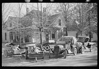 [Untitled photo, possibly related to: Trailers and cars belonging to farmers. They bring their tobacco for auction in all kinds of conveyances. Outside warehouse. Mebane, North Carolina]. Sourced from the Library of Congress.