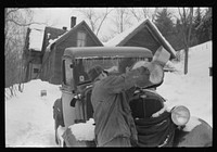 Hired man on farm near Woodstock, Vermont, usually empties the radiator in his car every evening and refills it again with water in the morning to save the cost of antifreeze. Sourced from the Library of Congress.