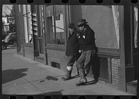 [Untitled photo, possibly related to: Townspeople of Woodstock, Vermont, discussing the severe winter on the street corner in center of town]. Sourced from the Library of Congress.