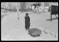 Child bringing home suitcase on sled, Franconia, New Hampshire. Sourced from the Library of Congress.