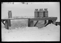 [Untitled photo, possibly related to: Hauling water in milk cans because usual source of supply is frozen. Putney Homestead farm near Woodstock, Vermont]. Sourced from the Library of Congress.
