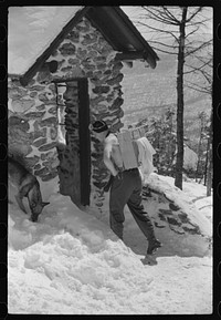 Forest ranger bringing in supplies which he has carried up the mountain on skiis to his hut which is also used by skiers in the winter. About half an hour later on his next trip down the mountain on skiis for more supplies he broke his leg. Near the top of Mount Mansfield, Smuggler's Notch, near Stowe, Vermont. Sourced from the Library of Congress.