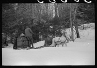 Walter Gaylord and son on sled with vat full of sap from sugar maple trees which is boiled down into syrup. Mad River Valley, Waitesfield, Vermont. He averages about 150 gallons of syrup annually, this year tapped only 600 out of his 1000 trees, because of unusually deep snow and late spring. He owns several farms; in this particular farm unit there are eighty acres. It has been in family for three generations. Has about thity-five or forty head of cattle, raises poultry and potatoes. Sourced from the Library of Congress.