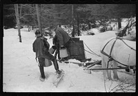 Walter Gaylord and son on sled with vat full of sap from sugar maple trees which is boiled down into syrup. Mad River Valley, Waitesfield, Vermont. He averages about 150 gallons of syrup annually, this year tapped only 600 out of his 1000 trees, because of unusually deep snow and late spring. He owns several farms; in this particular farm unit there are eighty acres. It has been in family for three generations. Has about thity-five or forty head of cattle, raises poultry and potatoes. Sourced from the Library of Congress.