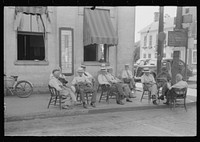 [Untitled photo, possibly related to: Farmers exchange news and greetings in front of courthouse on Saturday afternoon. Versailles, Kentucky]. Sourced from the Library of Congress.