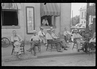 [Untitled photo, possibly related to: Farmers exchange news and greetings in front of courthouse on Saturday afternoon. Versailles, Kentucky]. Sourced from the Library of Congress.