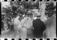 [Untitled photo, possibly related to: Priest talking to one of the parishioners before a church supper. Near Bardstown, Kentucky]. Sourced from the Library of Congress.