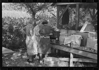 [Untitled photo, possibly related to: Parishoners preparing food for a benefit picnic supper on the grounds of St. Thomas Church. Near Bardstown, Kentucky]. Sourced from the Library of Congress.