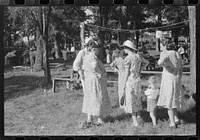 [Untitled photo, possibly related to: Parishoners gossiping while waiting for picnic supper at St. Thomas Church Picnic near Bardstown, Kentucky]. Sourced from the Library of Congress.