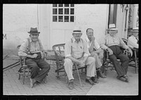 [Untitled photo, possibly related to: Townspeople visiting while sitting in front of Old Talbott Tavern on Saturday afternoon. Bardstown, Kentucky]. Sourced from the Library of Congress.