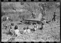 [Untitled photo, possibly related to: Homebuilt boiler pit made of mud and rocks where the sap from the sorghum cane is boiled down to the syrup.The man who does the cooking goes from one farmhouse to another and takes a share of the syrup for his work at the different mountaineers' homes in Breathitt County, Kentucky]. Sourced from the Library of Congress.