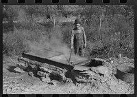 Homebuilt boiler pit made of mud and rocks where the sap from the sorghum cane is boiled down to the syrup.The man who does the cooking goes from one farmhouse to another and takes a share of the syrup for his work at the different mountaineers' homes in Breathitt County, Kentucky. Sourced from the Library of Congress.