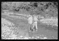 Going home from school. In Breathitt County, Kentucky. The school year begins in July and ends in January as most of the children have no shoes and insufficient clothing to walk the long distances over bad roads and up creek beds. Sourced from the Library of Congress.