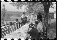 [Untitled photo, possibly related to: Mountaineers and farmers eating dinner served for benefit of the church in courthouse yard on court day. Campton, Wolfe County, Kentucky]. Sourced from the Library of Congress.