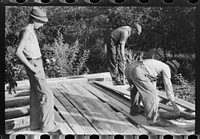 [Untitled photo, possibly related to: Mountaineer laying the new floor in his neighbor's home near Jackson, Breathitt County, Kentucky]. Sourced from the Library of Congress.