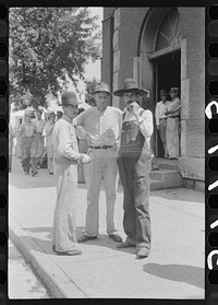 [Untitled photo, possibly related to: Farmers hanging in front of stores on Saturday, Jackson, Kentucky]. Sourced from the Library of Congress.