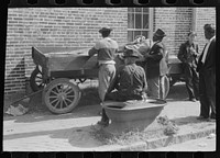 [Untitled photo, possibly related to: Taking a load of tobacco into the warehouse for the auction sale. Danville, Virginia]. Sourced from the Library of Congress.